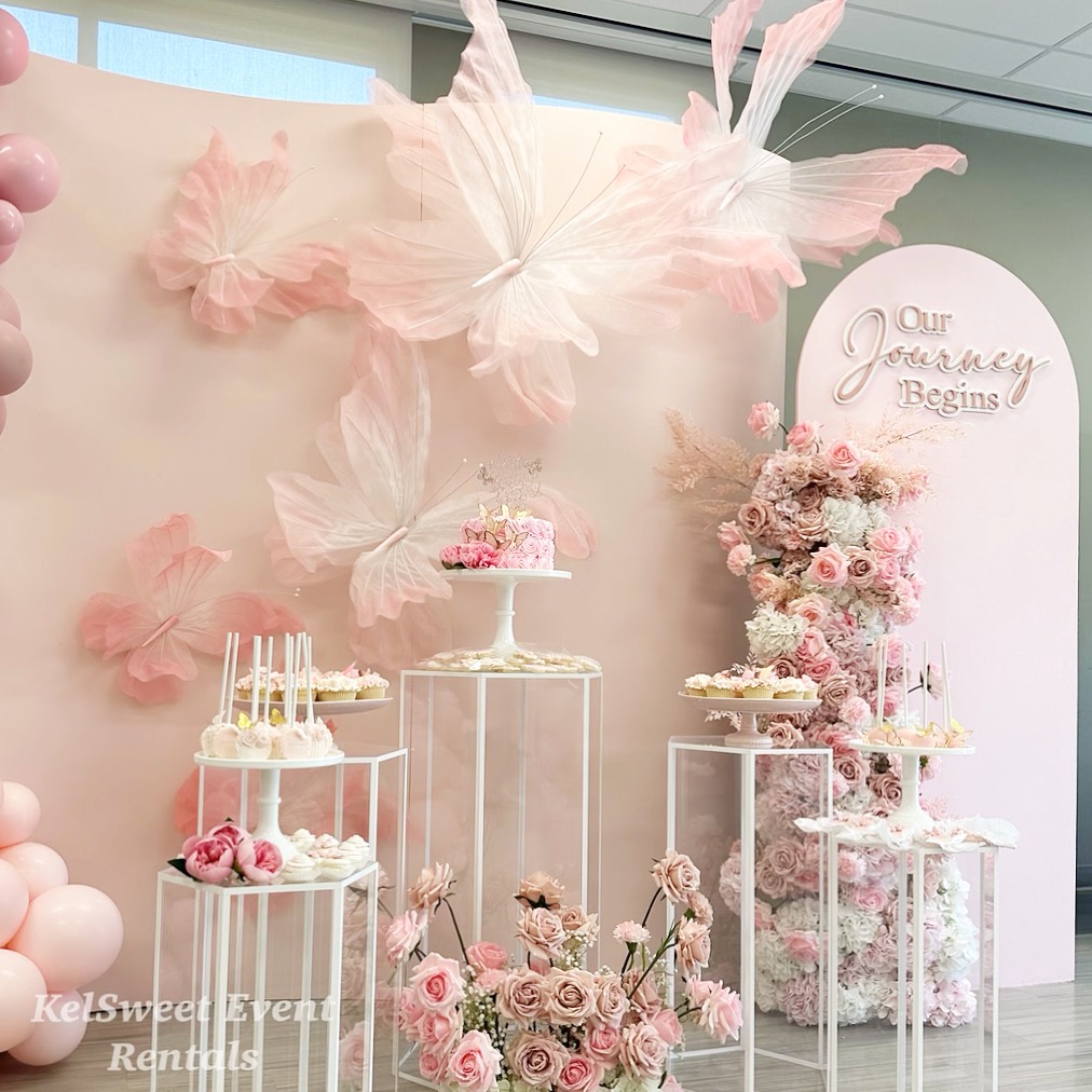 Custom curved backdrop with draping and floral accents for a milestone birthday
