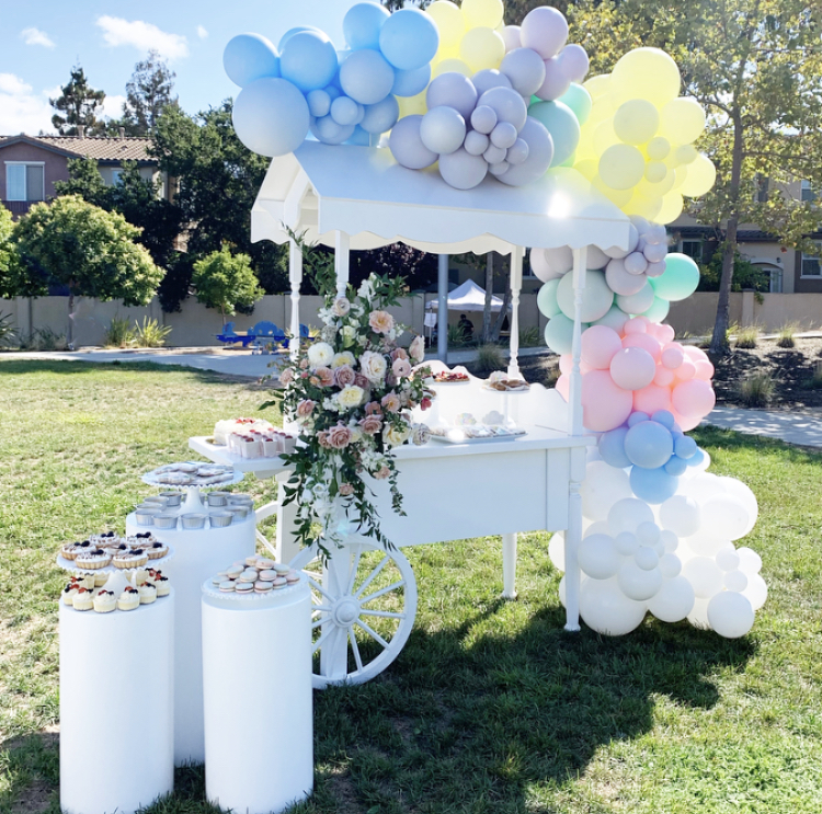 Mobile dessert cart styled for a garden reception
