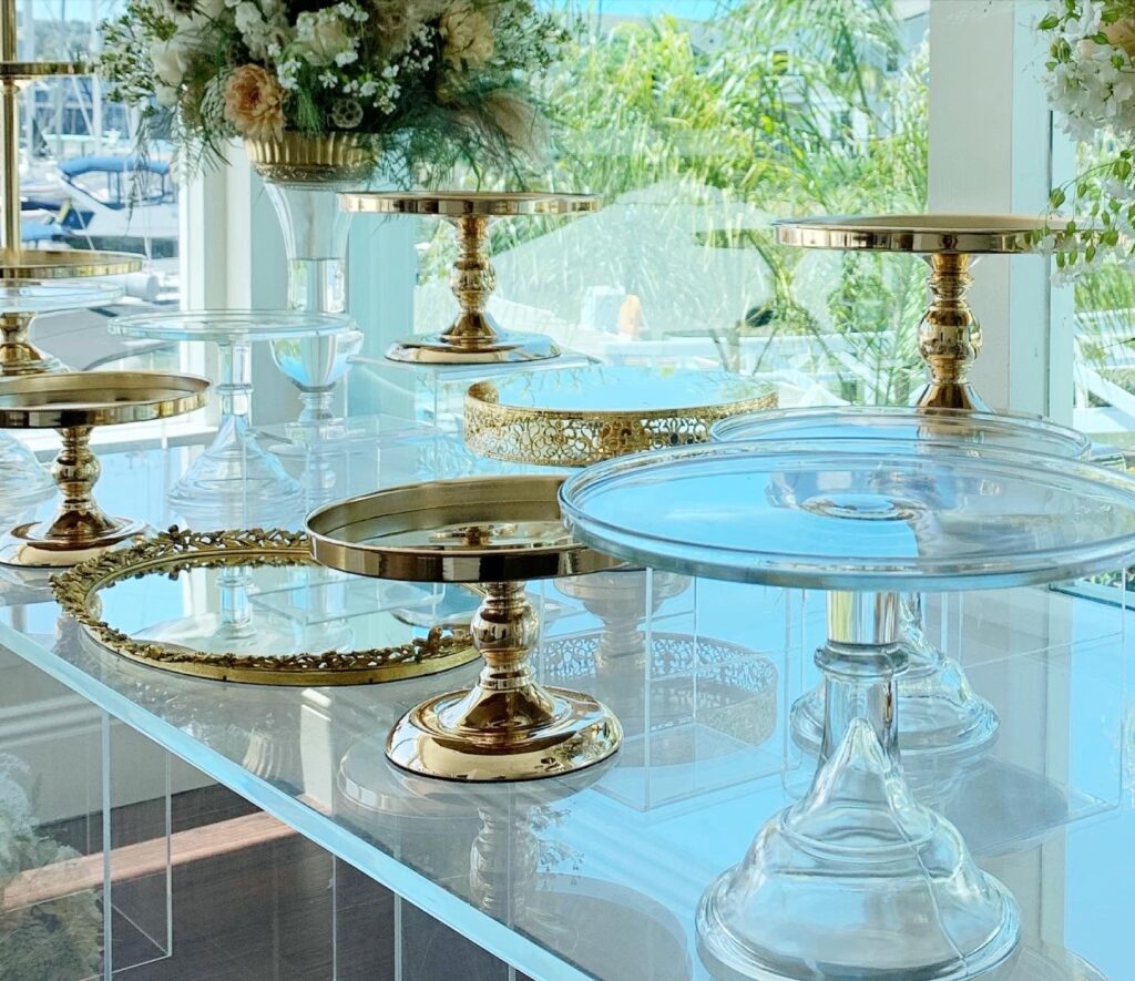 Curated dessert table with custom signage, candy jars, and layered cake display