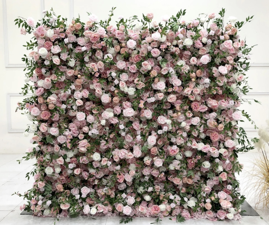 Floor-to-ceiling flower and grass wall installation in a neutral palette