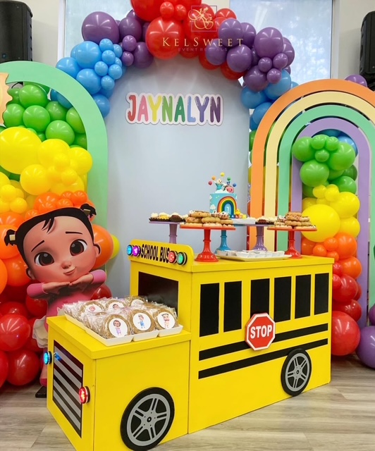 Themed props including oversized crescent moons and decorative pieces staged for photography