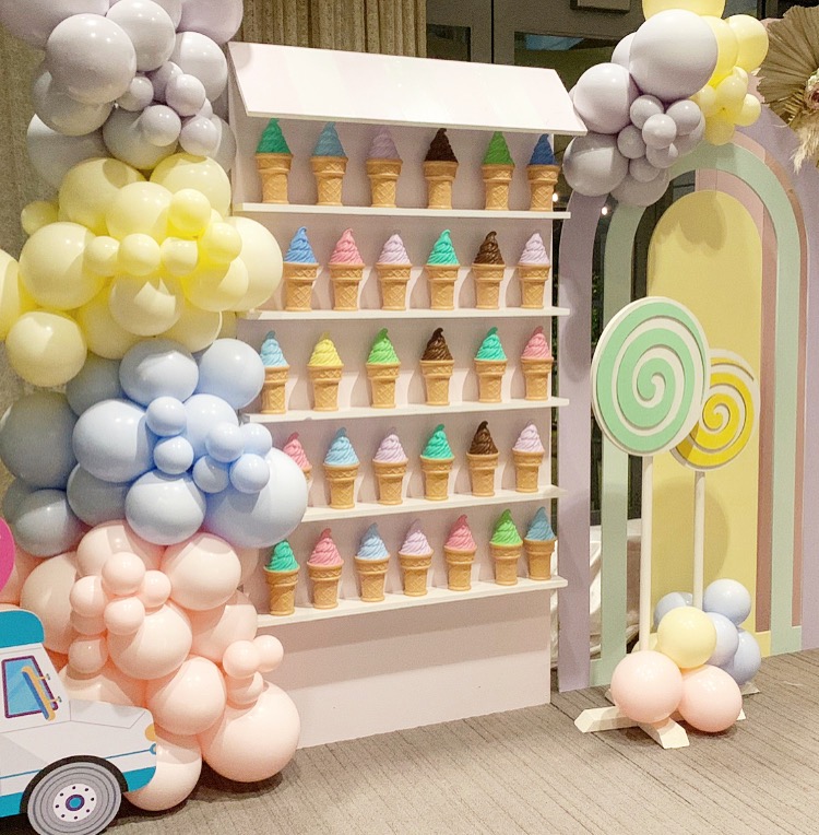 Tiered shelf wall styled with florals and decorative objects