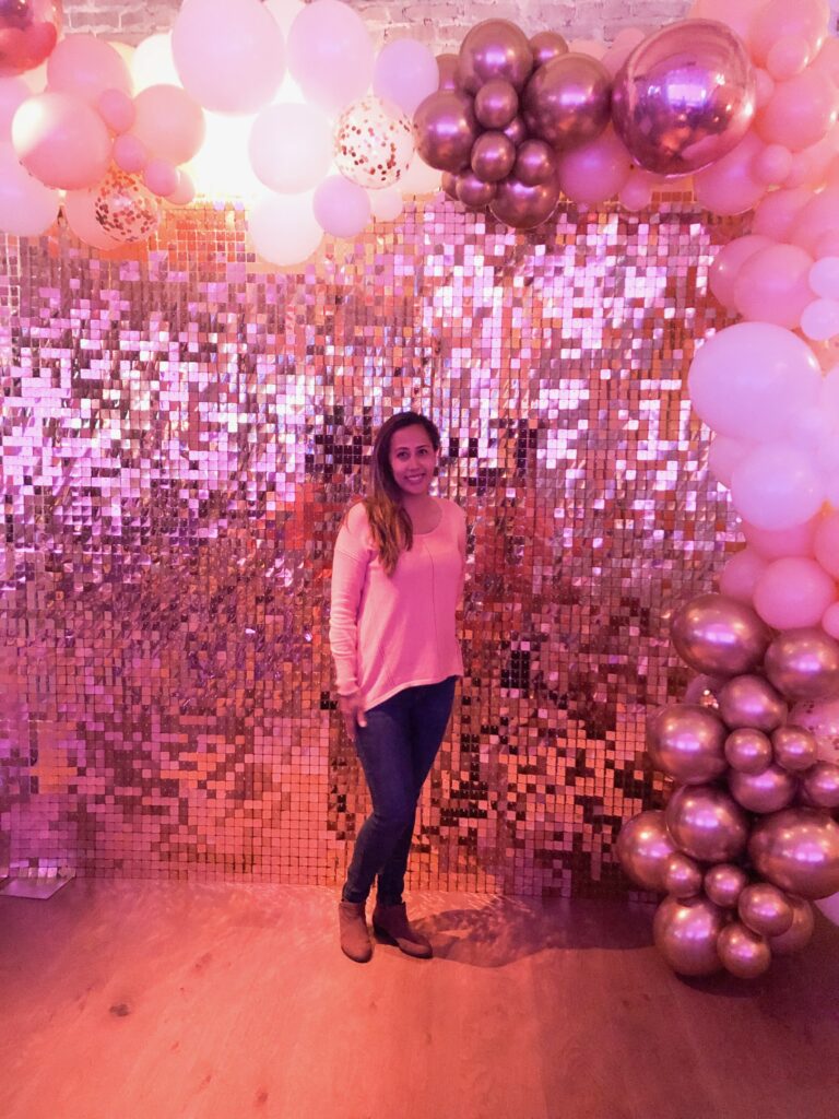 Gold sequin shimmer wall catching light during a birthday party photo setup