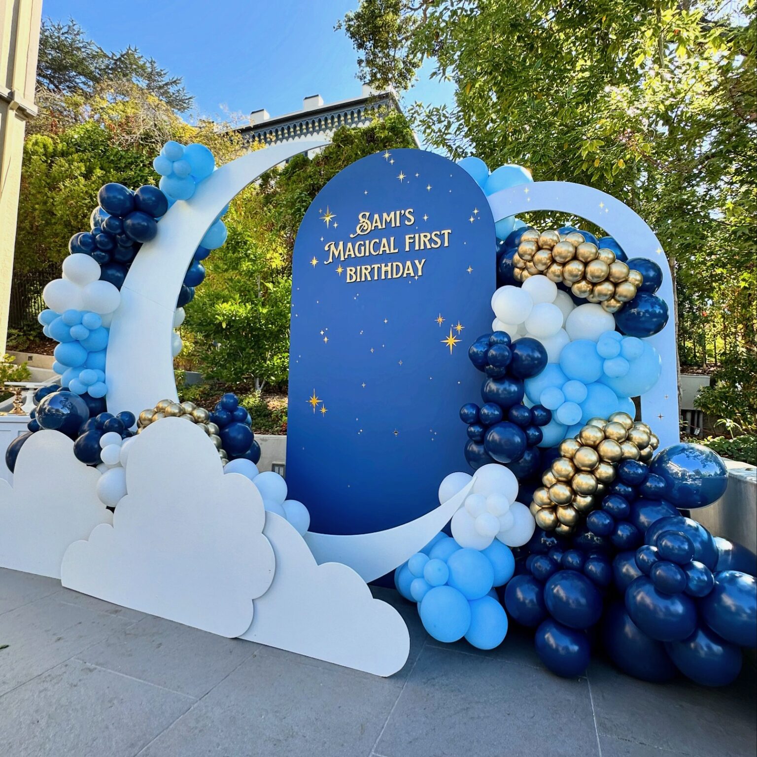 Custom backdrop installation with coordinated florals and signage for a wedding ceremony