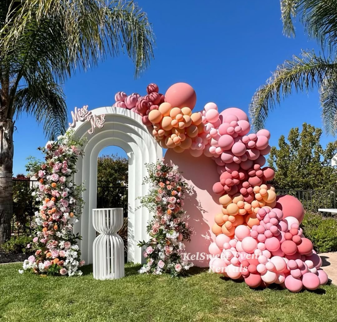 Elegant reception space with layered lighting, tablescape, and custom floral centerpieces