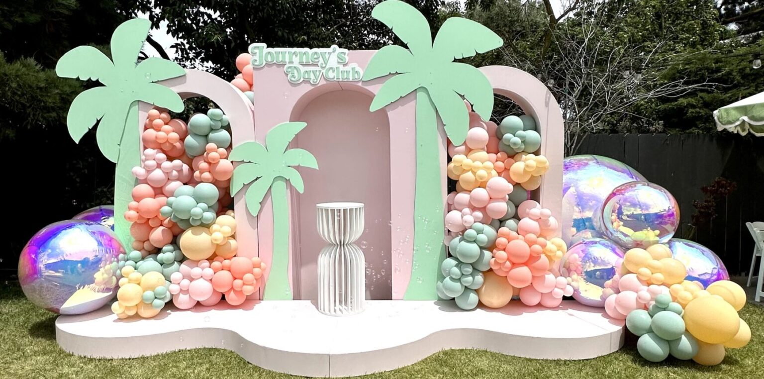 Summer tablescape installation with fresh florals, candles, and custom linens for a private dinner event in the Bay Area